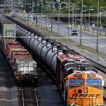 In this July 27, 2015, photo, traffic passes one of two mile-long oil trains parked near the King County Airport in Seattle. (Elaine Thompson/The Associated Press)