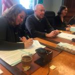 Jefferson County commissioners Kate Dean, David Sullivan and Kathleen Kler sign a human rights proclamation for Jefferson County at their meeting Monday morning. (Cydney McFarland/Peninsula Daily News)