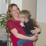 Robin Henrikson, Sequim School District board president, smiles as she holds her daughter after the announcement of the approval of both levies. (Erin Hawkins/Olympic Peninsula News Group)
