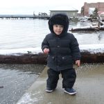 One-year-old Quinn Bronski of Port Townsend enjoys the snow Monday morning at the Salmon Club boat launch in downtown Port Townsend. (Cydney McFarland/Peninsula Daily News)