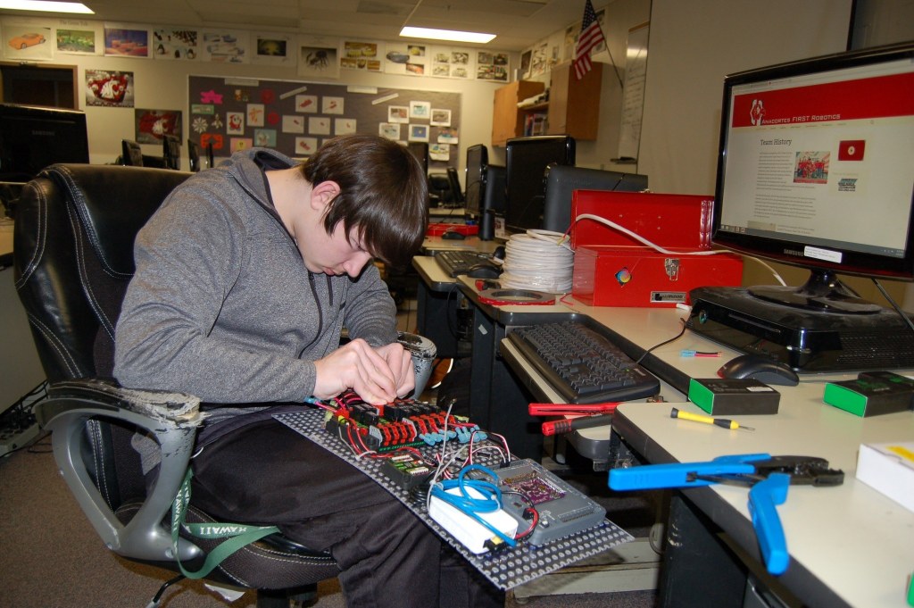 Sequim High School senior and Robotics Club President Riley Chase works on the electronics board for this year&rsquo;s robot that will compete in the FIRST Robotics Competition 2017. (Erin Hawkins/Olympic Peninsula News Group)
