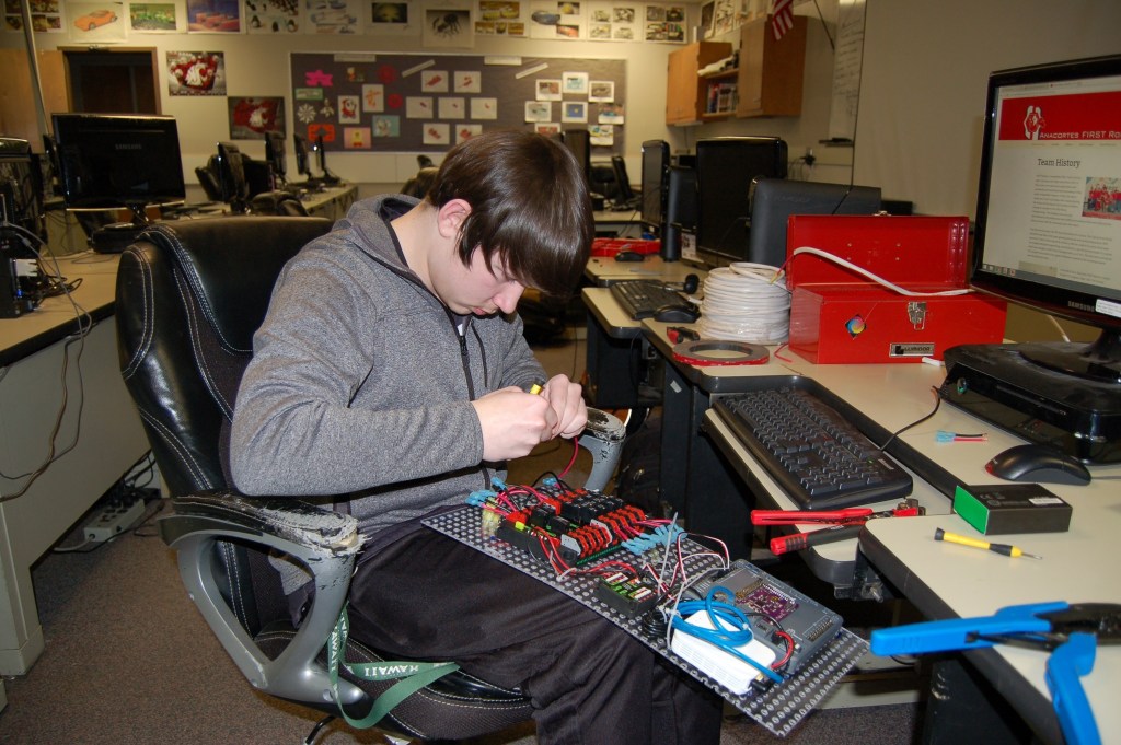 Sequim High School senior and Robotics Club President Riley Chase works on the electronics board for this year&rsquo;s robot that will compete in the FIRST Robotics Competition 2017. (Erin Hawkins/Olympic Peninsula News Group)