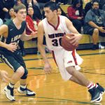 Keith Thorpe/Peninsula Daily News Neah Bay&rsquo;s Cameron Moore, right, dribbles past Cedar Park Christian&rsquo;s Jacob Schley during their playoff game on Feb. 16 at Port Angeles High School.