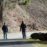 Two people walk on Olympic Hot Springs Road in Olympic National Park last Thursday. The road is closed to vehicle traffic. (Jesse Major/Peninsula Daily News)