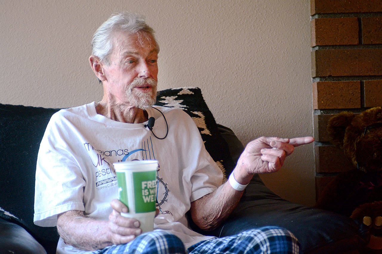 Richard Jones, 69, talks to reporters in his Sequim-area home Monday after being rescued from his car earlier that morning. He was trapped in his car for five days. (Jesse Major/Peninsula Daily News)