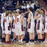Al Camp/Omak Chronicle Neah Bay seniors Vonte Aguirre (center, headband) and Tristin Johnson embrace after the Red Devils&rsquo; 60-57 loss to Tacoma Baptist in the Class 1B girls basketball state tournament Friday at Spokane Arena.