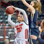 Al Camp/Omak Chronicle Neah Bay&rsquo;s Cei&rsquo;J Gagnon shoots while defended by Tacoma Baptist&rsquo;s Rachel VanLiew during the Class 1B girls basketball state tournament Friday at Spokane Arena.