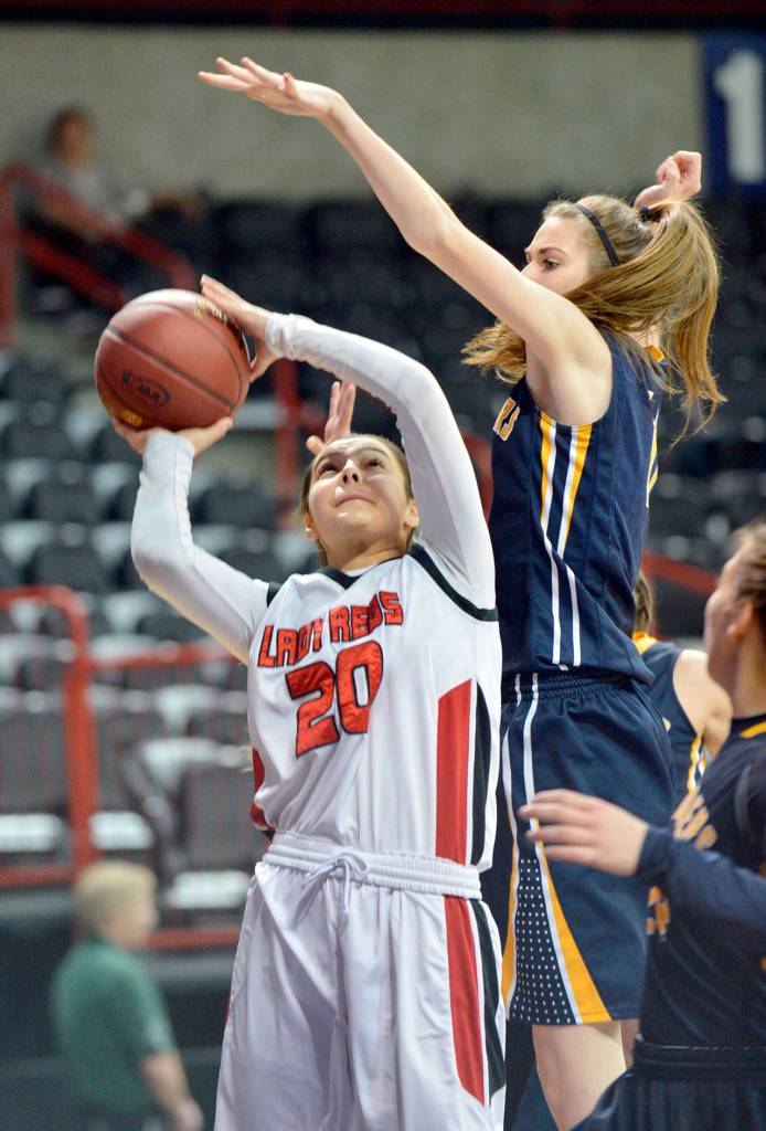 Al Camp/Omak Chronicle Neah Bay&rsquo;s Cei&rsquo;J Gagnon shoots while defended by Tacoma Baptist&rsquo;s Rachel VanLiew during the Class 1B girls basketball state tournament Friday at Spokane Arena.