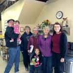 From left, Martin Shaughnessy, TAFY volunteer, holding Mara Northrop; Karen Beck, TAFY volunteer; Betsy Wharton, TAFY volunteer registered nurse and gardener; Mara&rsquo;s sister Mackenzie Northrop; Susan Hillgren, TAFY executive director; and Pam Fosnes, TAFY volunteer financial director. (Vivian Elvis Hansen/Peninsula Daily News)