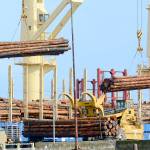 Logs destined for export are loaded onto the Shikoku Island, a Panamanian bulk carrier, in Port Angeles on Monday. (Jesse Major/Peninsula Daily News)