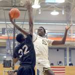 Rick Ross/Peninsula College                                Peninsula&rsquo;s Omar Lo, right, attacks the rim against the defense of Tacoma&rsquo;s Ravion Bell during the Pirates&rsquo; 75-64 loss to the Titans on Friday at Everett Community College.