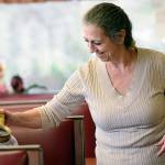 Blackberry Cafe owner Roxanne Olsen pours coffee for customers. Olsen is frustrated by break-ins of her restaurant, with the most recent being last week. (Jesse Major/Peninsula Daily News)