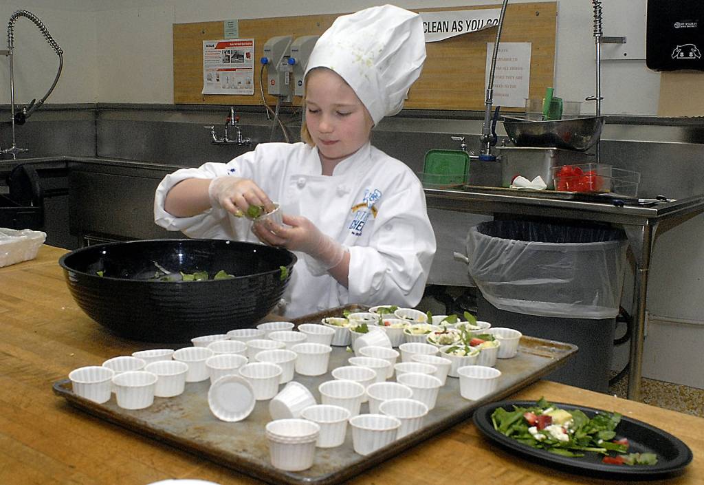 Keith Thorpe/Peninsula Daily News                                Nine-year-old Zoe Leffers, a fourth-grade student at Hamilton School in Port Angeles, creates a healthy salad Friday in the Port Angeles School District kitchen as part of the 2017 Sodexo Future Chefs Challenge. The event, part of a national initiative to promote healthy eating, brought together student teams from five Port Angeles elementary schools in a competition to cook up culinary creations with the theme of &ldquo;Healthy Comfort Foods.&rdquo;