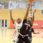 Rick Ross/for Peninsula Daily News Peninsula&rsquo;s Jenise McKnight (5) battles for a rebound against Umpqua&rsquo;s Dajanay Powell in a second-round NWAC Tournament game in Everett on Sunday.