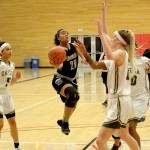 Rick Ross/for Peninsula Daily News Peninsula&rsquo;s Yamelei Rodriguez drives to the basket against Umpqua defenders in Peninsula&rsquo;s second-round NWAC Tournament game in Everett on Sunday.