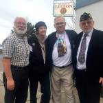 Carl Hanson, chair of COAST; deForest Walker, executive director of COAST; Chaplain Richard Nordberg, and Andy Okinczyc, American Legion Post 26 commander, stand in front of the American Legion which hosts the winter shelter in the building&rsquo;s lower level. (Cydney McFarland/Peninsula Daily News)