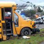 Jefferson Elementary School Principal Joyce Mininger, right, walks through the scene where a passenger car collided with a Port Angeles School District bus at 10th and Peabody streets in Port Angeles on Tuesday. (Keith Thorpe/Peninsula Daily News)