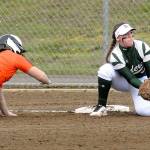 Keith Thorpe/Peninsula Daily News Port Angeles first baseman Kylee Reid, right, tries to catch Central Kitsap&rsquo;s Marissa Adams off the bag during the first inning on Tuesday at the Dry Creek athletic fields in Port Angeles.