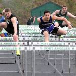 Keith Thorpe/Peninsula Daily News Riley Martin of Sequim, center, moves into first place ahead of Nathanael Kjormoe of North Kitsap, left, to win the boys 110m hurdles during Fridays Port Angeles Invitational at Port Angeles High School. Port Angeles&rsquo; Daimon Batchelor, right, took forth in the event.