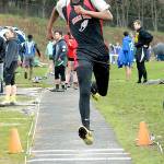 Keith Thorpe/Peninsula Daily News Anthony Bitegeko of Neah Bay goes into his step in the triple jump on Friday at Port Angeles High School.