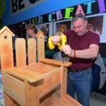 Larry Stacey of Walma&rsquo;s Creations builds a bench planter box during the 19th annual Soroptimist Gala Garden Show in Sequim on Sunday. (Jesse Major/Peninsula Daily News)