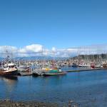 The Makah Marina is shown in Neah Bay with Waadah Island and the mountains of Vancouver Island providing a backdrop. (Zorina Barker/for Peninsula Daily News)
