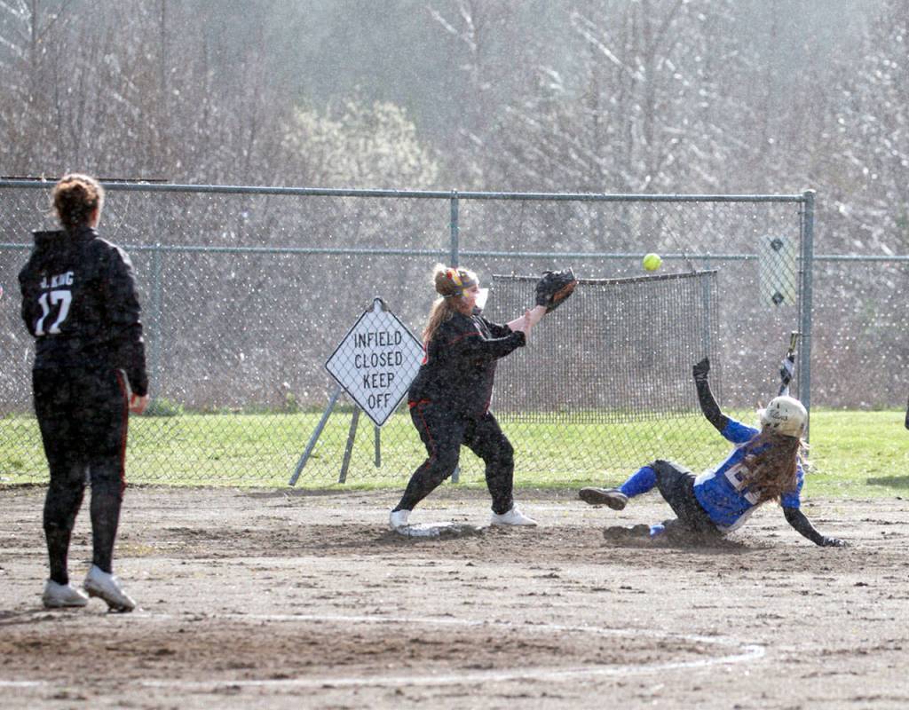 Steve Mullensky/for Peninsula Daily News                                Chimacum&rsquo;s Bradyn Nelson, gets in under the tag and successfully steals third base before the ball reaches Port Townsend&rsquo;s Dani Graham, during the Cowboys&rsquo; 20-0 win over the rival Redhawks at Blue Heron Middle School