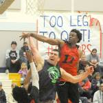 Lonnie Archibald/for Peninsula Daily News Kasey Ulin (center), playing for the Olympic Sporting Goods of Forks puts up a shot between defenders Jalen Ballard (3) and Terrell Mack (11) in the championship game during the Nate Crippen Memorial Tournament played Sunday at Forks High School. NW Dons of Portland, Ore., defeated Olympic Sporting Goods 80 to 68 to take the championship in the upper division. The Breakwater Boys of Clallam and Neah Bay took first in the lower division.