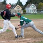Steve Mullensky/for Peninsula Daily News                                Port Angeles&rsquo; first baseman Dane Bradow, right, makes an out on Port Townsend&rsquo;s Marc Evans during the Roughriders&rsquo; 12-0 win over the Redhawks. as the ball and the out on Redhawk Marc Evans at 1st during a Monday game in Port Townsend.