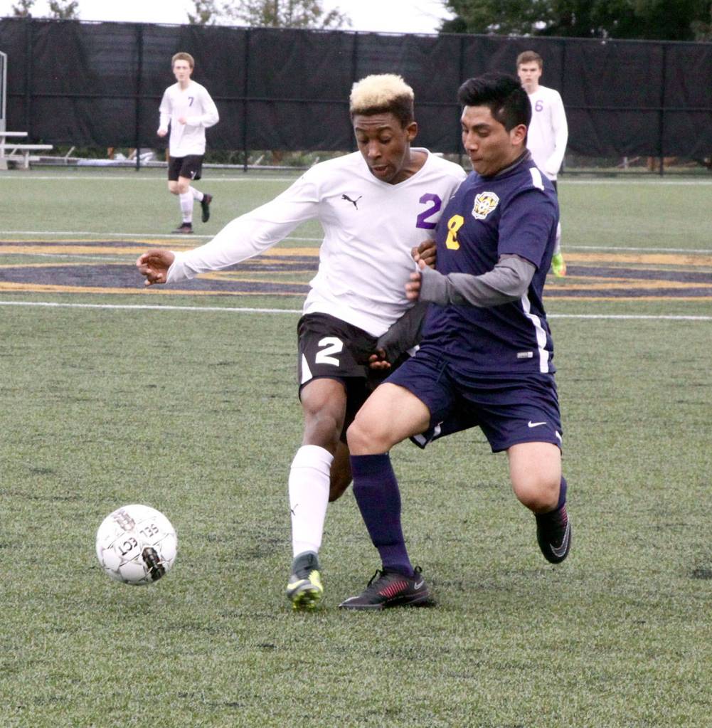 Dave Logan/for Peninsula Daily News                                Sequim&rsquo;s Josiah Urquia, left, and Forks&rsquo; Julio Salazar fight for possession of the ball during the Wolves&rsquo; 9-0 victory over the Spartans at Wally Sigmar Field at Peninsula College.