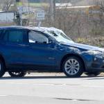Clallam County Fire District No. 3 Chief Ben Andrews examines a car involved in a two-vehicle rollover collision on U.S. Highway 101 at Old Olympic Highway on Thursday that resulted in minor injuries to its occupants. (Keith Thorpe/Peninsula Daily News)