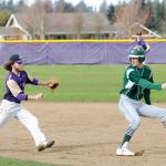 Michael Dashiell/Olympic Peninsula News Group Port Angeles&rsquo; Luke Angevine, right, attempts to avoid a rundown by Sequim&rsquo;s Gavin Velarde. Angevine was tagged out, but his Roughriders rallied for a 10-7 win.