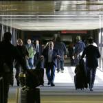 Pedestrians walk through a skybridge at Seattle-Tacoma International Airport near the international arrivals area Tuesday. (Ted S. Warren/The Associated Press)