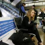 Asti Gallina, left, a volunteer law student from the University of Washington, sits at a station near where passengers arrive on international flights at Seattle-Tacoma International Airport on Tuesday. (Ted S. Warren/The Associated Press)                                Asti Gallina, left, a volunteer law student from the University of Washington, sits at a station near where passengers arrive on international flights at Seattle-Tacoma International Airport on Tuesday. (Ted S. Warren/The Associated Press)