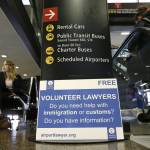 Ted S. Warren (2)/The Associated Press                                Asti Gallina, left, a volunteer law student from the University of Washington, sits at a station near where passengers arrive on international flights at Seattle-Tacoma International Airport on Tuesday. Gallina was volunteering with the group Airport Lawyer, which also offers a secure website and mobile phone app that alerts volunteer lawyers to ensure travelers make it through customs without trouble.