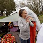 In this photo taken March 23, Sheryl, left, a homeless woman who declined to give her last name, talks with outreach worker Brenda Frazier as part of a new team of outreach workers and police officers that go out and connect homeless people to services in Seattle. Sheryl said she has lived in a tent in a greenbelt near Interstate Highway 90 for about six months. (Elaine Thompson/The Associated Press)