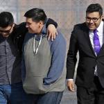 Daniel Ramirez Medina, center, walks out of the Northwest Detention Center in Tacoma with his attorney, Luis Cortes, right, and his brother, who has not been identified by name, after Ramirez was released from federal custody Wednesday. (Ted S. Warren/The Associated Press)