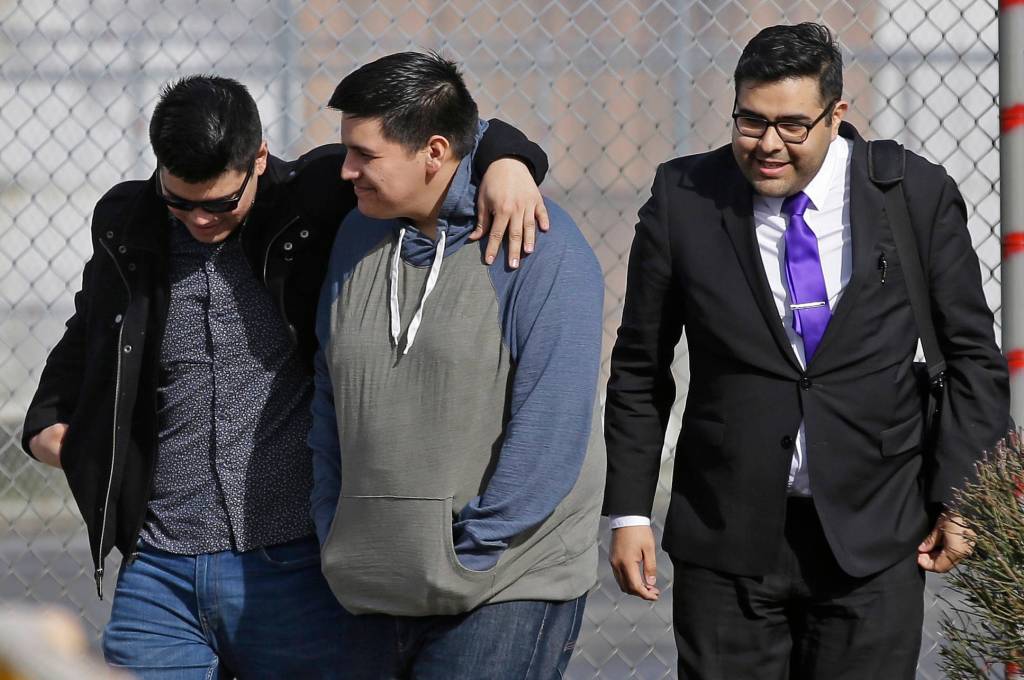 Daniel Ramirez Medina, center, walks out of the Northwest Detention Center in Tacoma with his attorney, Luis Cortes, right, and his brother, who has not been identified by name, after Ramirez was released from federal custody Wednesday. (Ted S. Warren/The Associated Press)