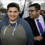 Daniel Ramirez Medina, left, walks with with his attorney, Luis Cortes, right, after Ramirez was freed from custody at the Northwest Detention Center in Tacoma on Wednesday. (Ted S. Warren/The Associated Press)