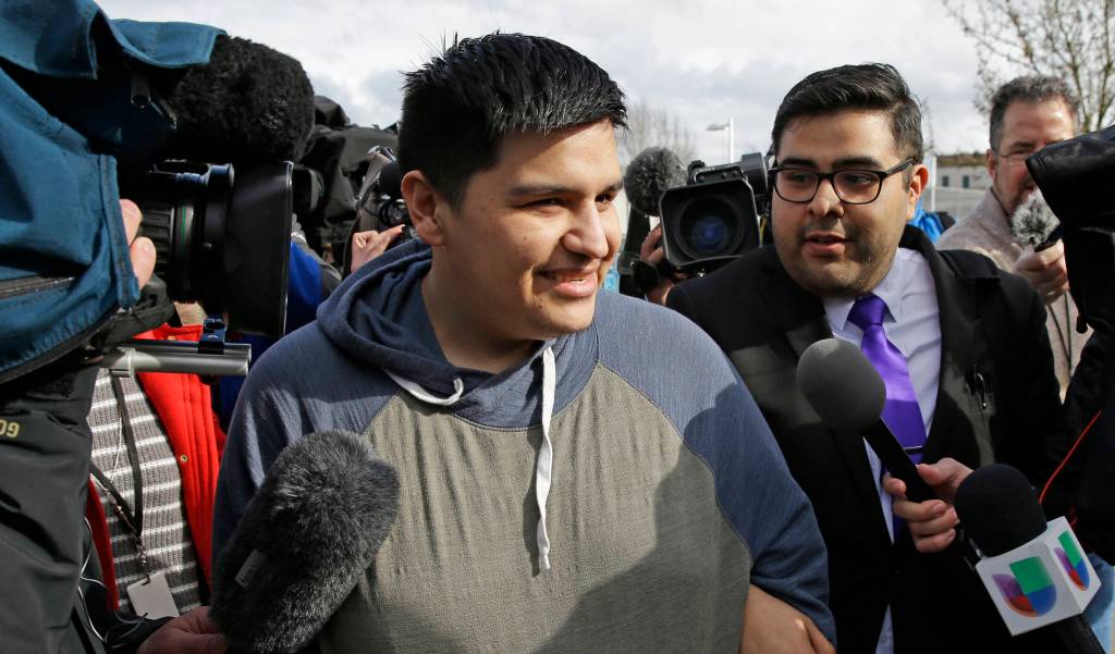 Daniel Ramirez Medina, center, briefly talks to reporters as he walks with his attorney, Luis Cortes, right, after Ramirez was freed from custody at the Northwest Detention Center in Tacoma on Wednesday. (Ted S. Warren/The Associated Press)