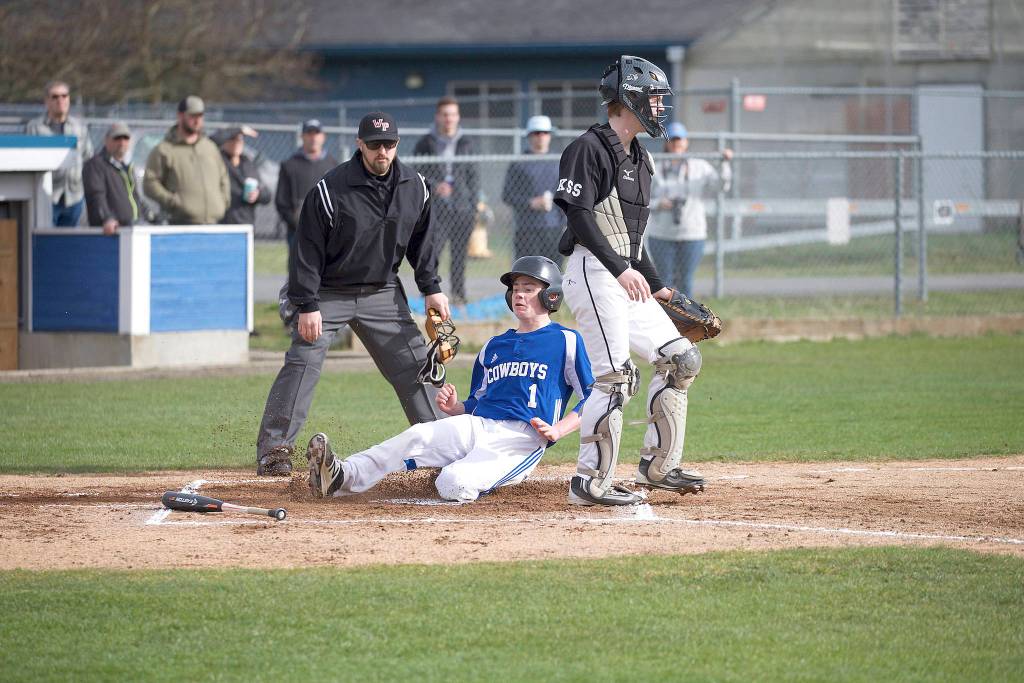 Steve Mullensky/for Peninsula Daily News                                Chimacum&rsquo;s Issac Purser beats the throw and slides across home plate for a run during the Cowboys&rsquo; 7-1 loss to Klahowya.