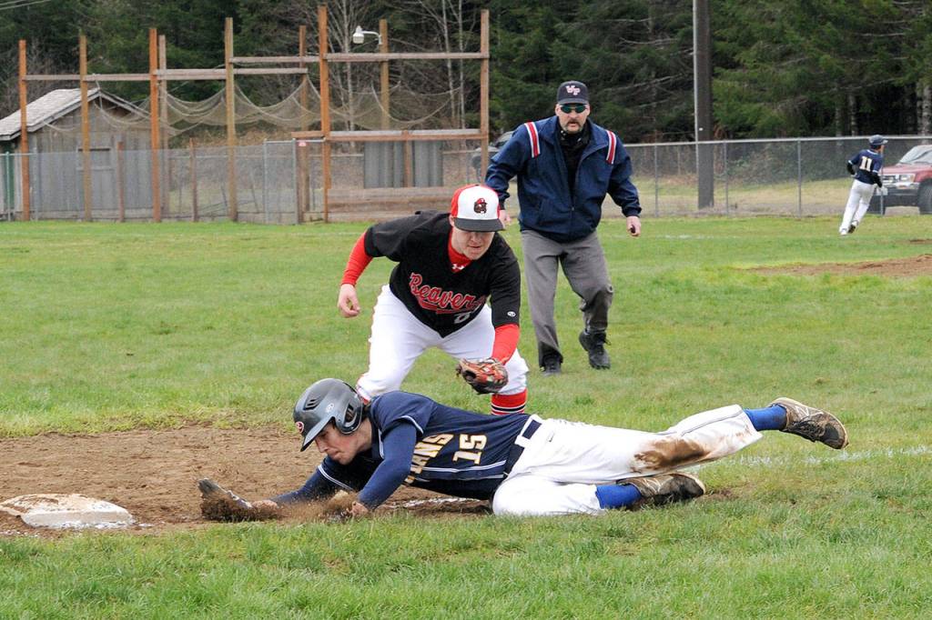 Lonnie Archibald/for Peninsula Daily News Forks baserunner Billy Palmer (15) tries to avoid the tag of Tenino third baseman Miles Cannon.