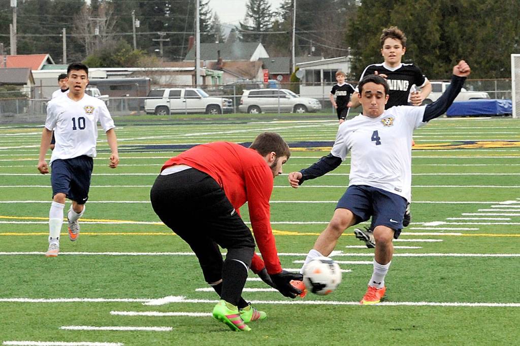 Lonnie Archibald/for Peninsula Daily News Forks&rsquo; Saul Avila, right, competes with Tenino goalkeeper Dylan Billings for the ball during the Spartans&rsquo; 8-0 win over the Beavers at Spartans Stadium. Also in the action is Spartan Samuel Gomez (10) and Tenino&rsquo;s Laitan Jordan (11).