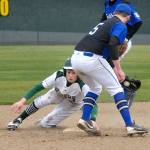 Keith Thorpe/Peninsula Daily News Port Angeles&rsquo; Joel Wood, left, holds onto second base after beating the throw to North Mason shortstop Donavan Shew and stealing the base during a loss to the Bulldogs at Volunteer Field.