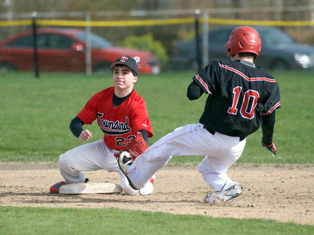 Steve Mullensky/for Peninsula Daily News Port Townsend&rsquo;s second baseman, Tristen Van Leuven, left, was in time to cover the bag but the throw was late and Coupeville&rsquo;s Jack Howland took the base during the Redhawks&rsquo; 9-1 loss to the Wolves.