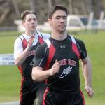 Keith Thorpe/Peninsula Daily News Neah Bay&rsquo;s Cameron Buzzell races to win his heat in the 100 meter dash as teammate Chris Tageant follows behind on Thursday in Joyce.