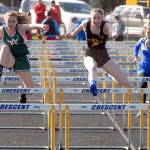 Keith Thorpe/Peninsula Daily News Clallam Bay&rsquo;s Molly McCoy, center, races ahead of Port Angeles&rsquo; Delaney Wenzl, right, and Crescent&rsquo;s Acacia Bergstrom in the girls 100 meter hurdles on Thursday at Crescent High School in Joyce.