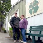 Caption: Bill and Sue McIntire stand in front of a row of buildings used to house animals and vendors during the Jefferson County Fair. (Cydney McFarland/Peninsula Daily News)