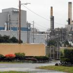 The shuttered Nippon Paper Industries USA mill in Port Angeles sits idle with its sign covered Friday. (Keith Thorpe/Peninsula Daily News)