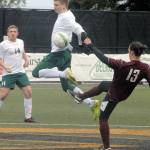 Keith Thorpe/Peninsula Daily News Port Angeles&rsquo; Michael Scott, center, leaps high to block a pass by Ketchikan&rsquo;s Giovaniu Covelli as Scott&rsquo;s teammate, Karsten Hertzog, left, looks on during Saturday&rsquo;s nonleague matchup at Peninsula College in Port Angeles.